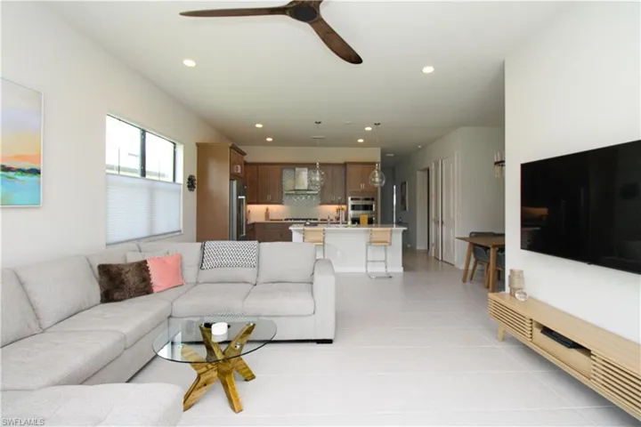 Tiled living room featuring ceiling fan