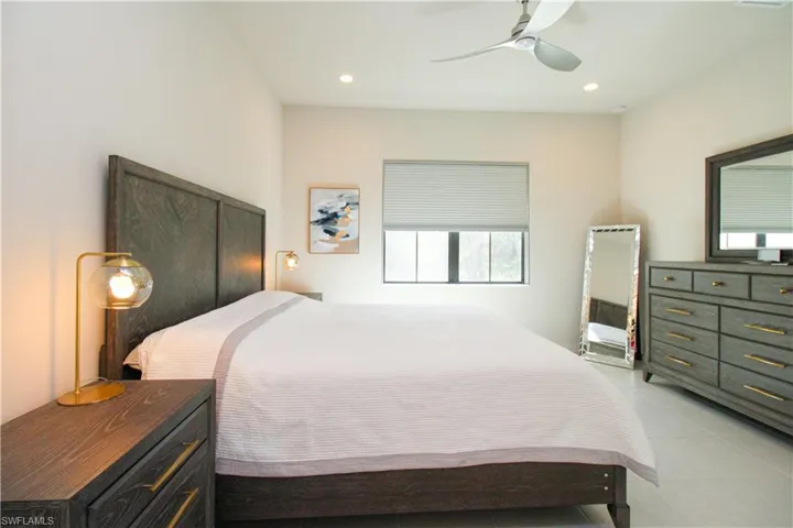 Tiled bedroom with ceiling fan