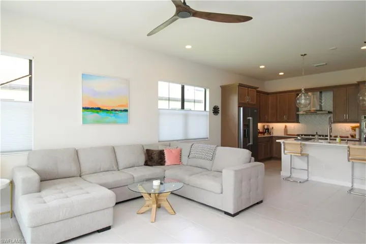 Tiled living room featuring ceiling fan