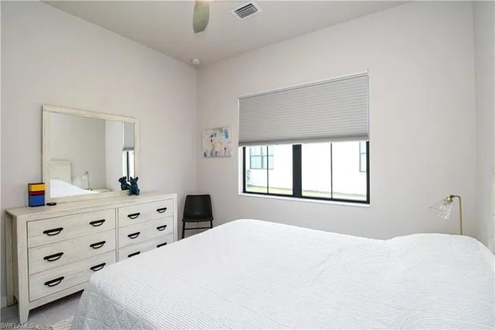 Bedroom featuring light tile patterned flooring and ceiling fan