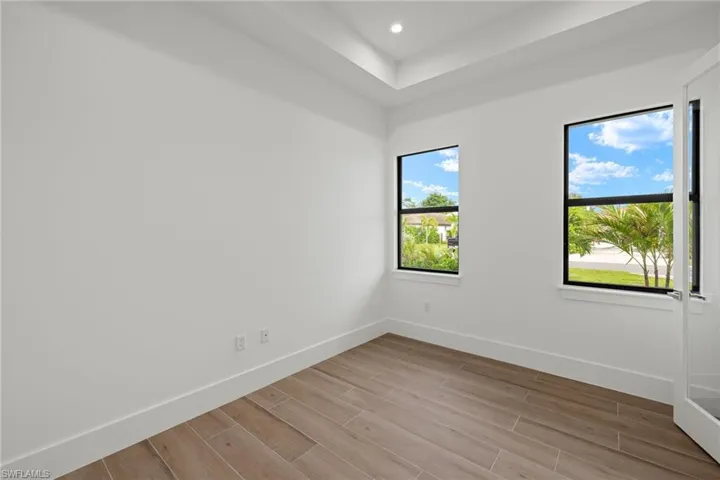 Empty room with a healthy amount of sunlight and light hardwood / wood-style flooring