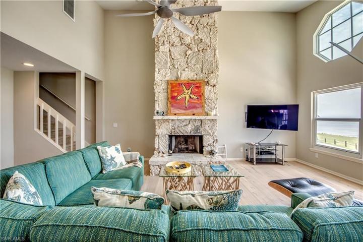 Living Room with great water view of Charlotte Harbor and a limestone fireplace