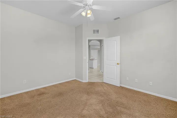 BONUS room with ceiling fan and carpet