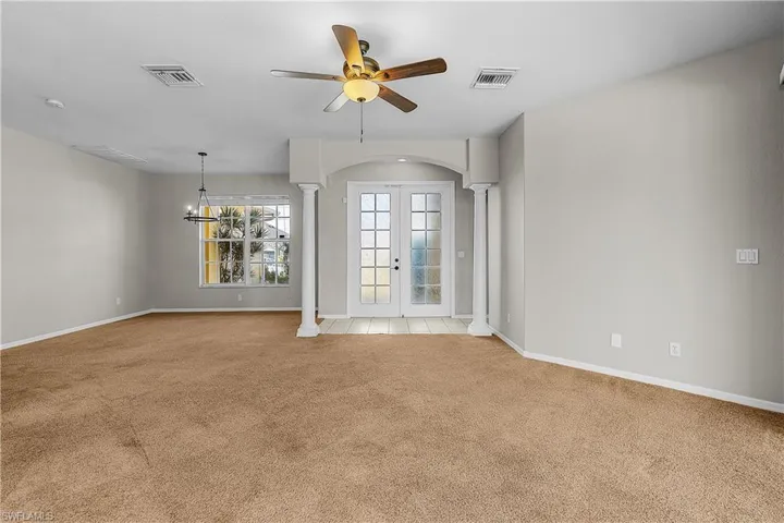 Entry foyer & dining room featuring ornate columns & arched walkways