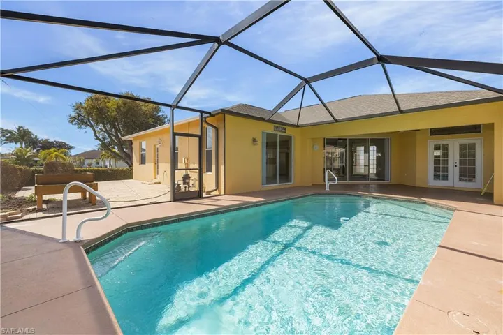 Outdoor pool featuring Full Screened Cage, a lanai, and a patio area