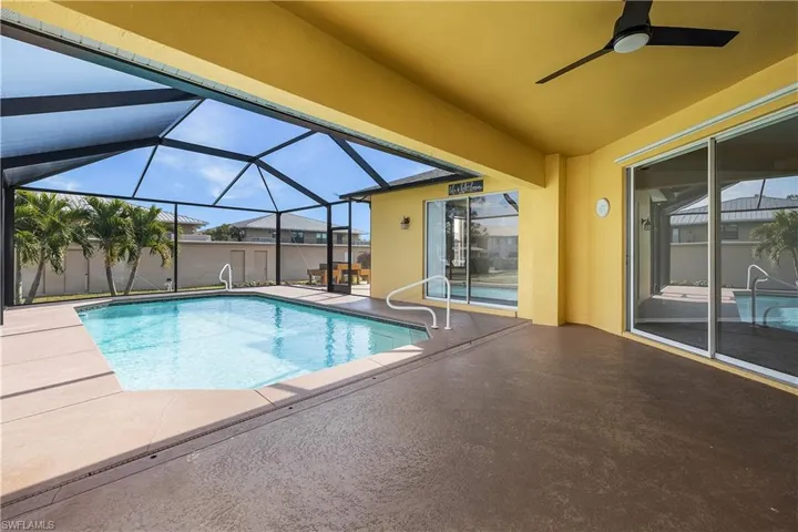 Outdoor pool featuring a covered lanai area.