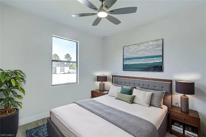 Bedroom with ceiling fan and wood finished floors
