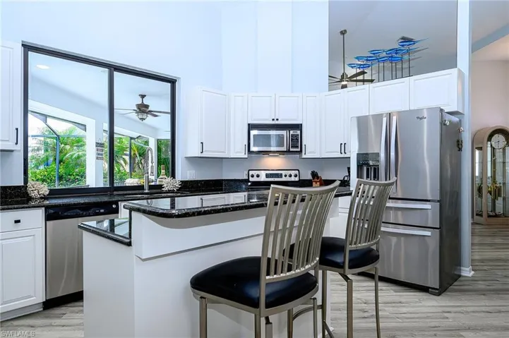 Kitchen featuring white cabinetry, light hardwood / wood-style floors, appliances with stainless steel finishes, and sink