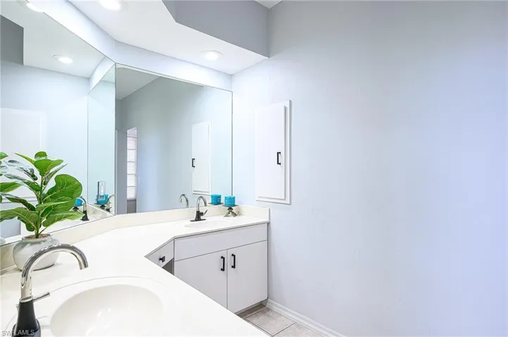 Bathroom featuring tile patterned floors and double vanity