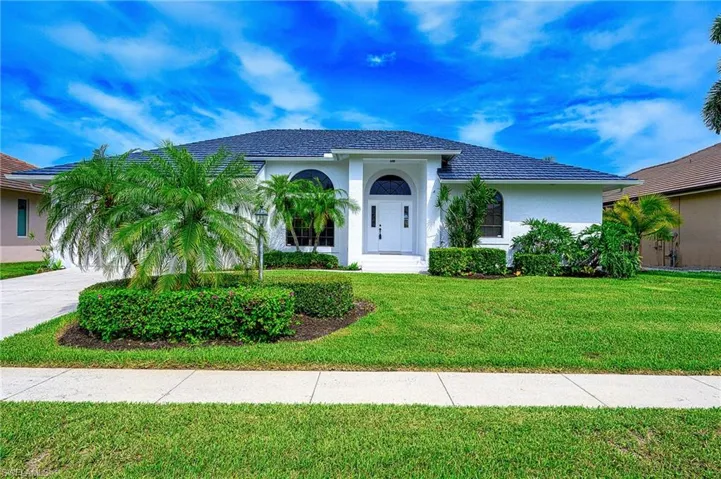 Mediterranean / spanish house with a front yard