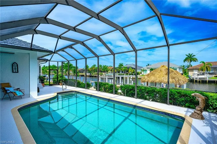 View of pool featuring a water view, a patio, and a lanai