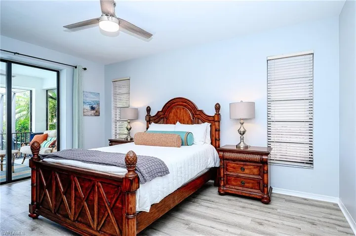 Bedroom featuring access to outside, light hardwood / wood-style flooring, and ceiling fan