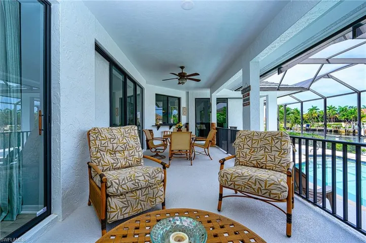Sunroom / solarium with a wealth of natural light and ceiling fan