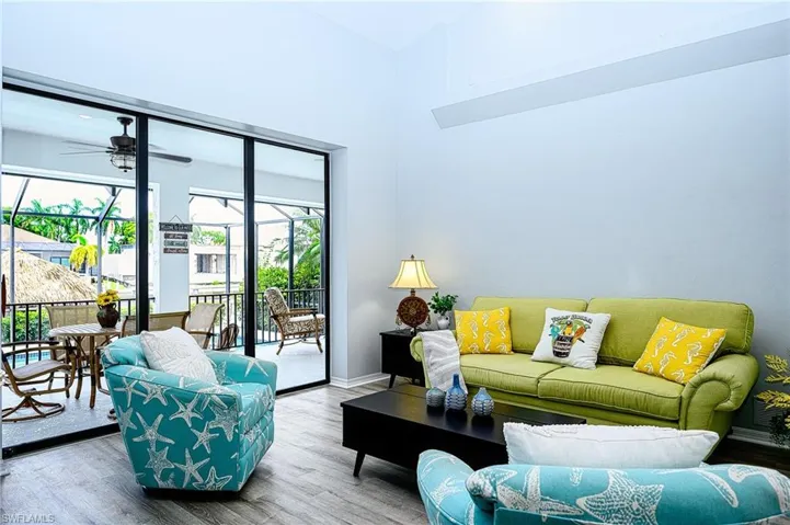 Living room with hardwood / wood-style floors and ceiling fan