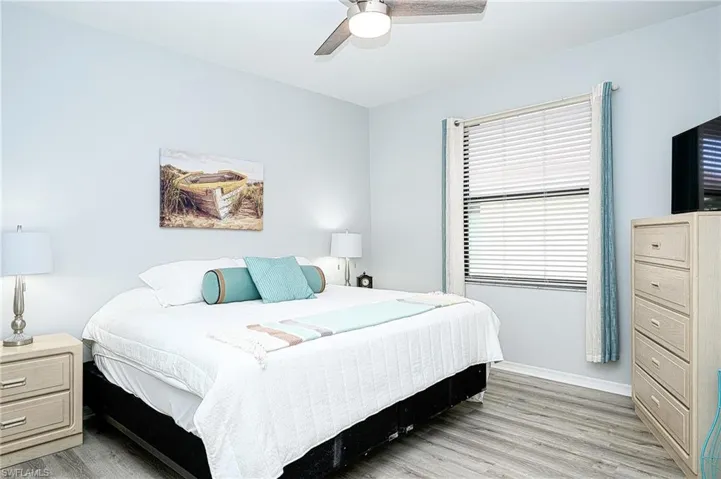 Bedroom featuring light hardwood / wood-style floors and ceiling fan