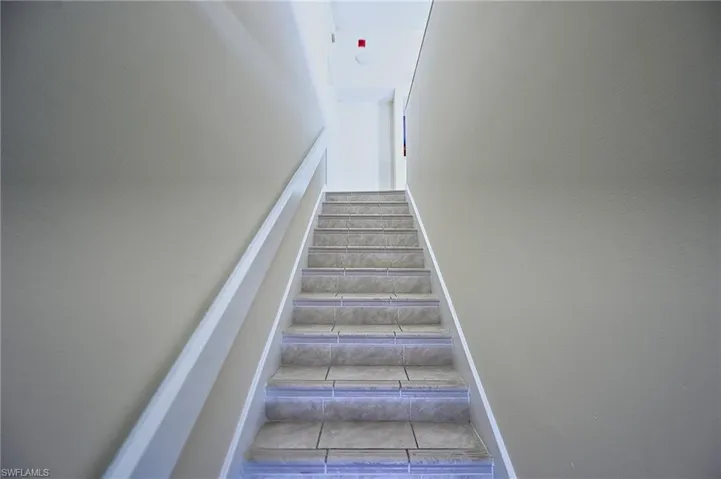 Stairs with tile patterned floors