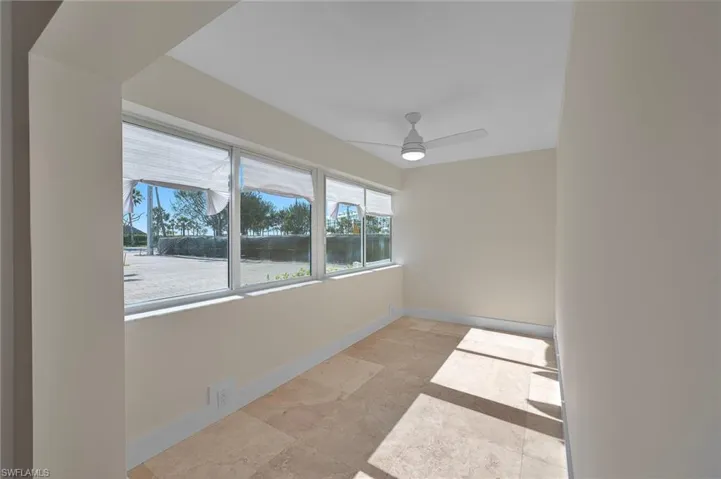 Spare room with a ceiling fan and baseboards