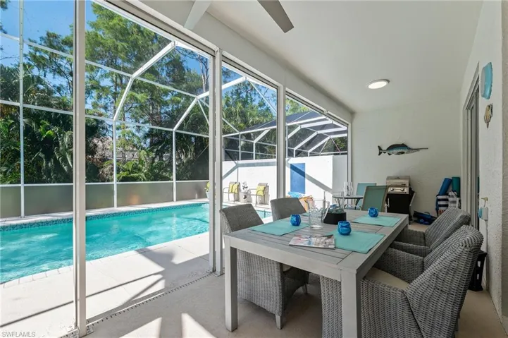 View of swimming pool with a lanai and a patio
