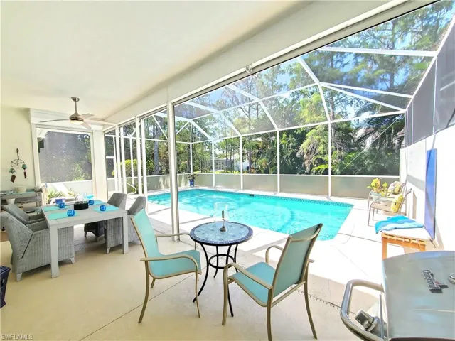 View of pool with a patio, a lanai, and ceiling fan
