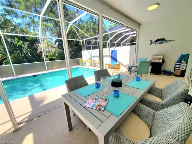 View of swimming pool featuring a patio and a lanai