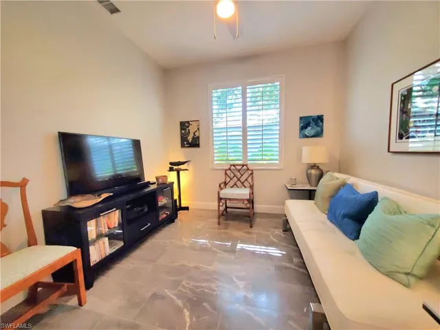 Living room with tile flooring and ceiling fan