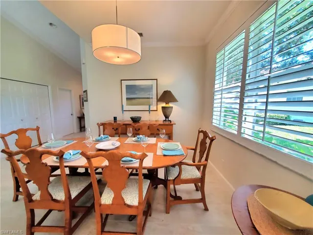 Dining space featuring ornamental molding and lofted ceiling