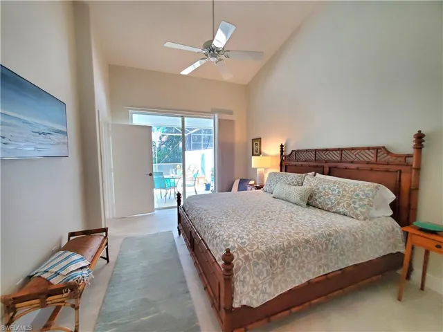 Carpeted bedroom with high vaulted ceiling, access to exterior, and ceiling fan