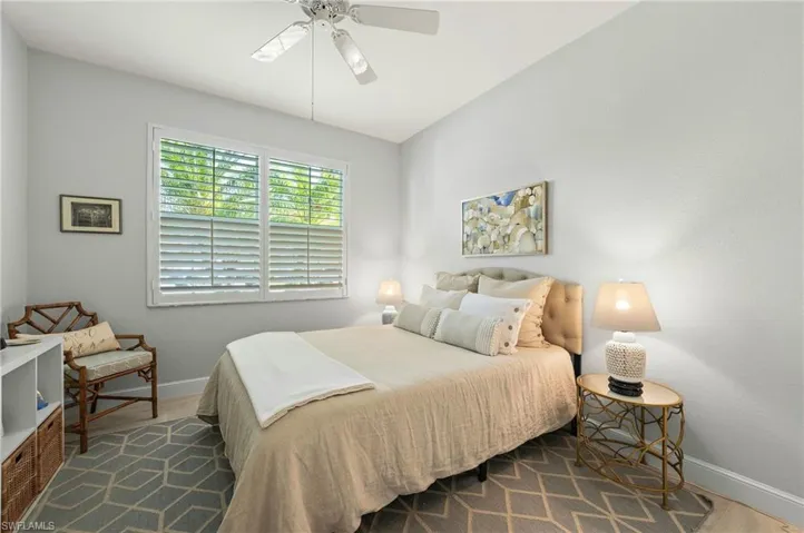 Bedroom with dark hardwood / wood-style floors and ceiling fan