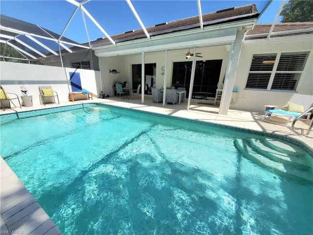 View of pool with a patio, a lanai, and ceiling fan