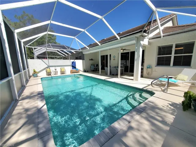 View of pool featuring a patio, a lanai, and ceiling fan
