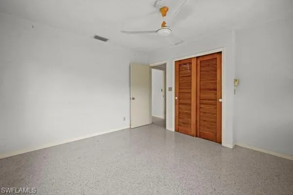 Unfurnished bedroom featuring a closet and ceiling fan