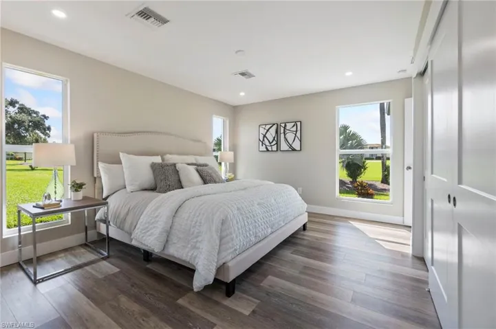 Bedroom with dark hardwood / wood-style flooring