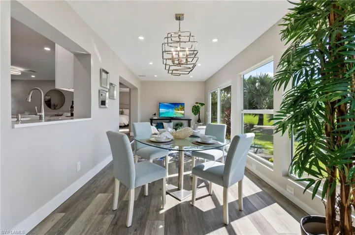 Dining room featuring a notable chandelier, wood-type flooring, and sink