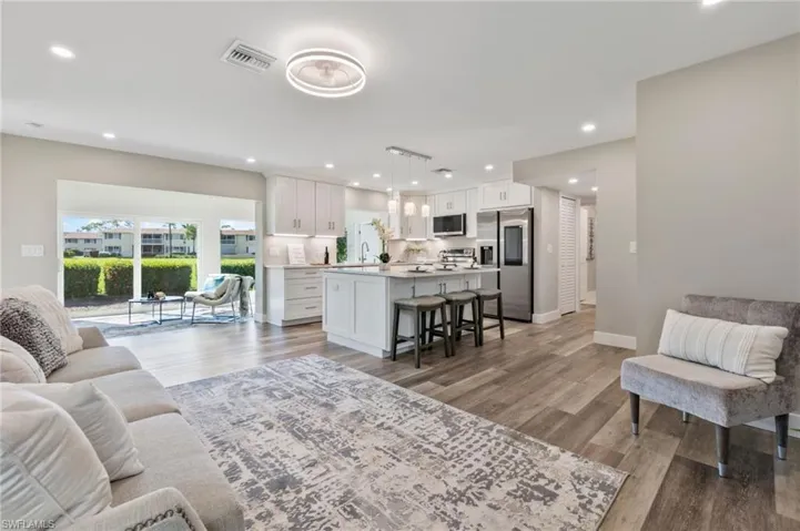 Living room with sink and hardwood / wood-style floors