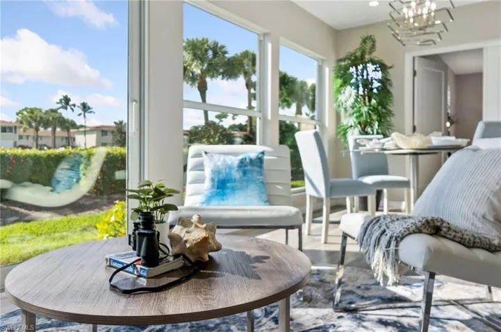Sunroom / solarium with an inviting chandelier