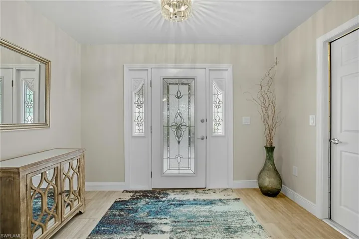 Front entry door with decorative glass inserts and matching sidelights