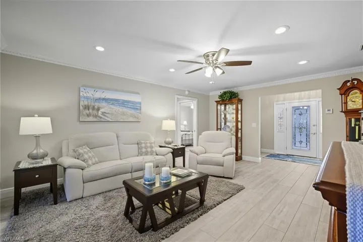 Living area featuring wood-finish flooring, recessed lighting, and a ceiling fan