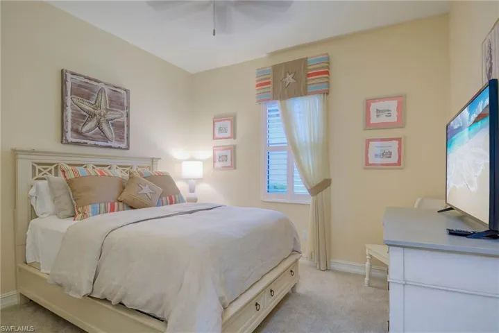 Bedroom with light carpet and ceiling fan
