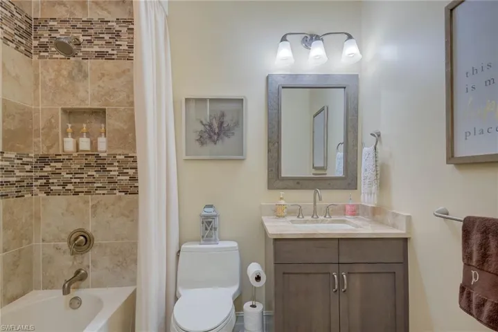 Full bath featuring vanity and shower / tub combo