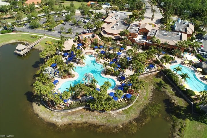 Aerial view of property's location with a pool area and a large body of water