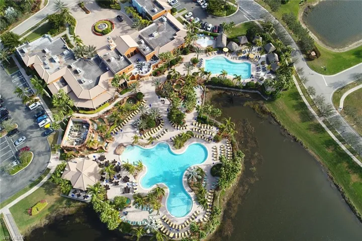 Aerial overview of property's location with a pool and a large body of water