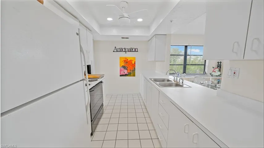 Bright galley kitchen with ceramic tile