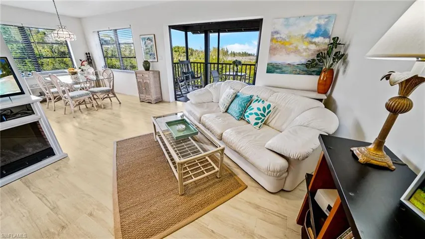 Electric fireplace dining area, and pocket sliders to the screened balcony overlooking preserved mangrove forest.