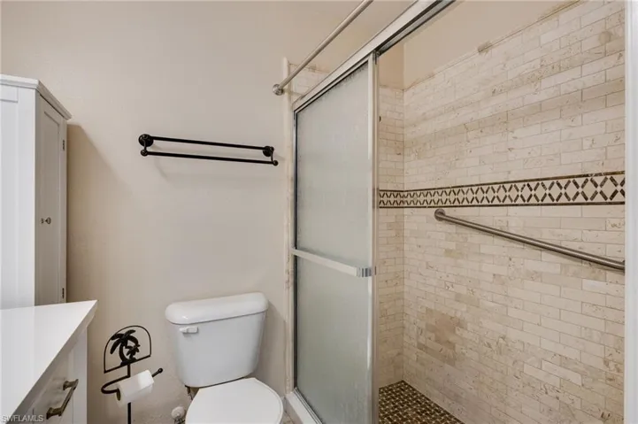 Bathroom featuring vanity and a stall shower