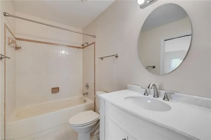 Full bathroom featuring bathtub / shower combination, vanity, and light tile patterned flooring