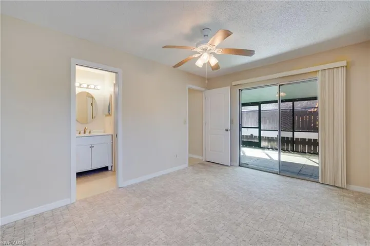 Unfurnished bedroom featuring ceiling fan, a textured ceiling, and access to outside