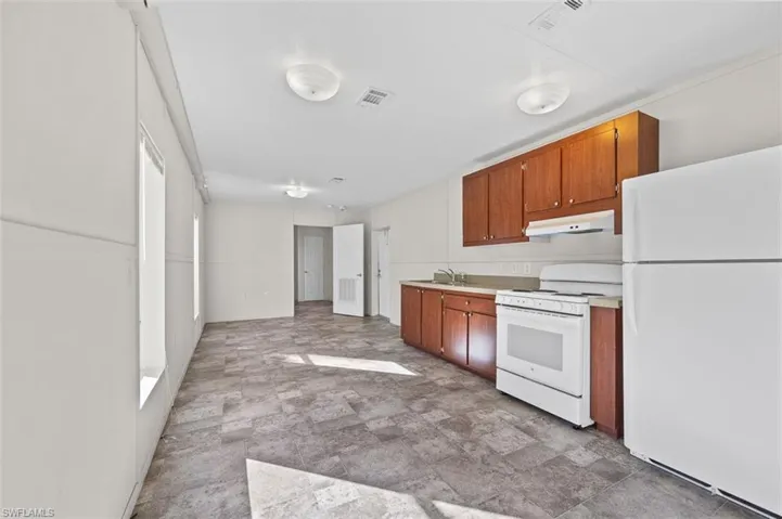 Kitchen with white appliances and sink