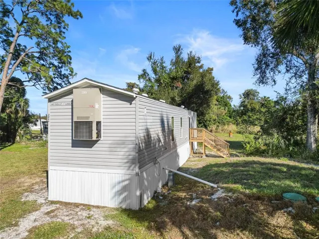View of side of property featuring a lawn