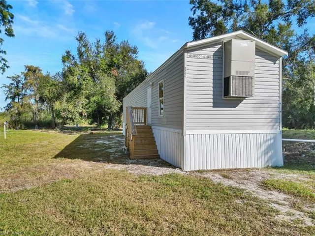 View of property exterior with a yard