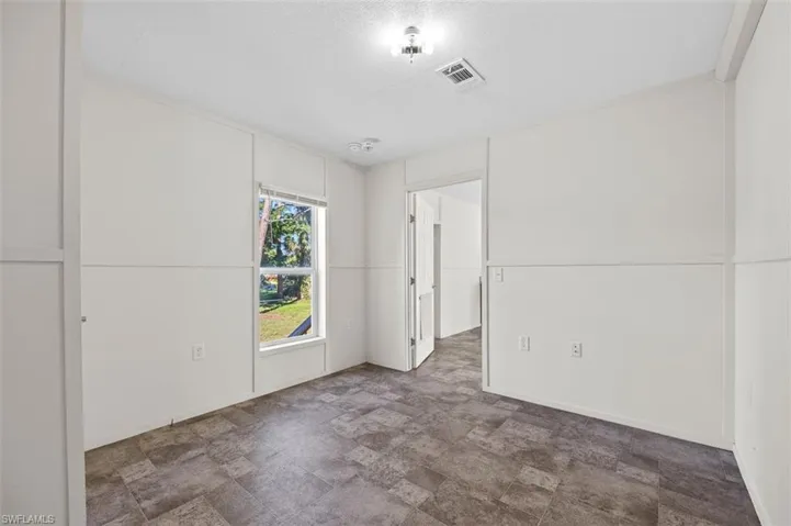 Unfurnished room with a textured ceiling